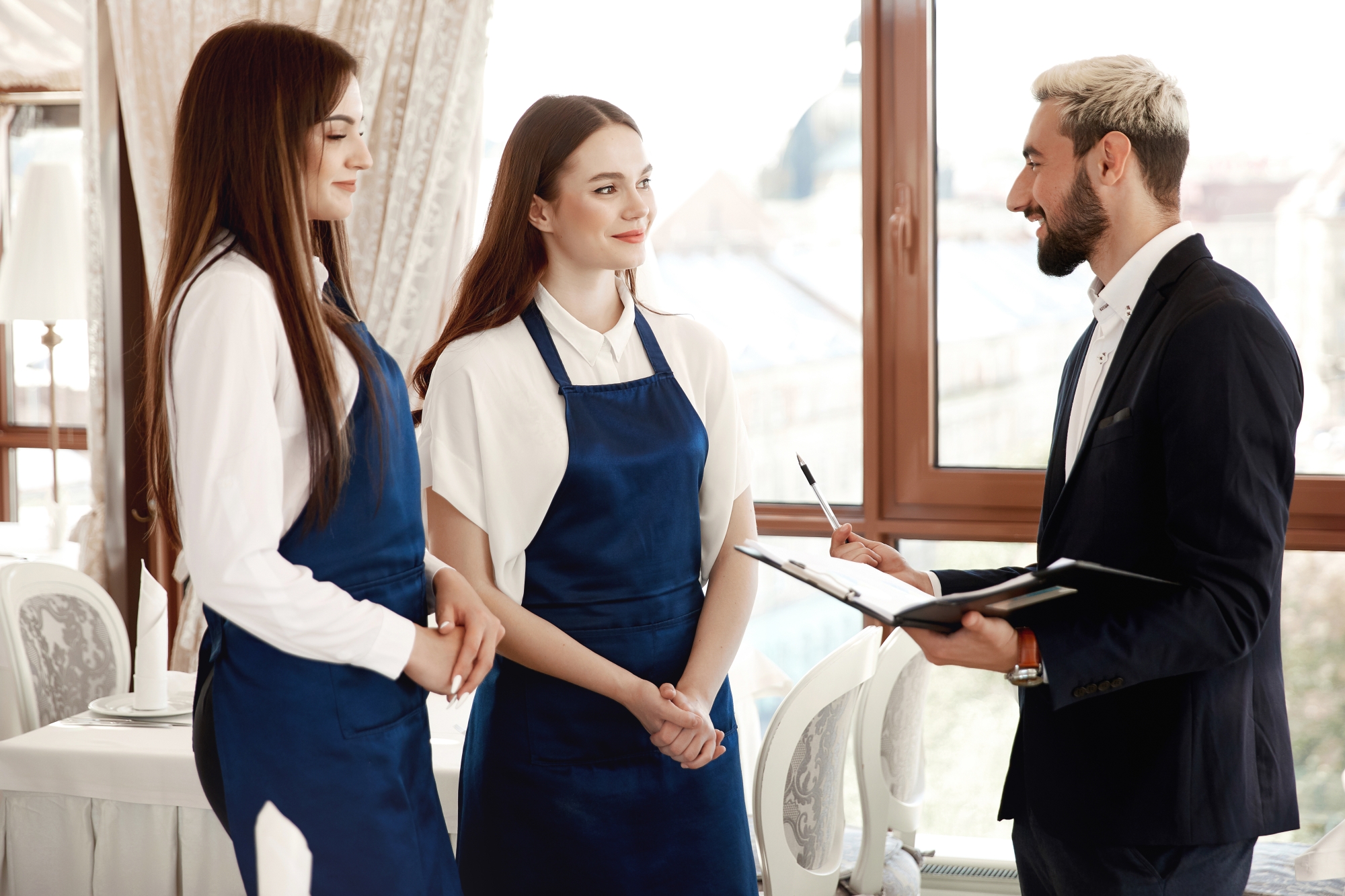 Handsome Restaurant Manager Is Talking Waitresses About Work Process